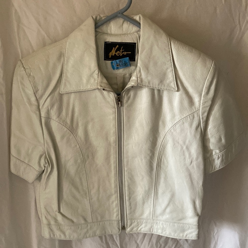 White soft leather made miniskirt and jacket has been professionally cleaned.